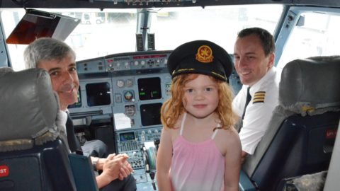 5 year old in airplane cockpit with pilots